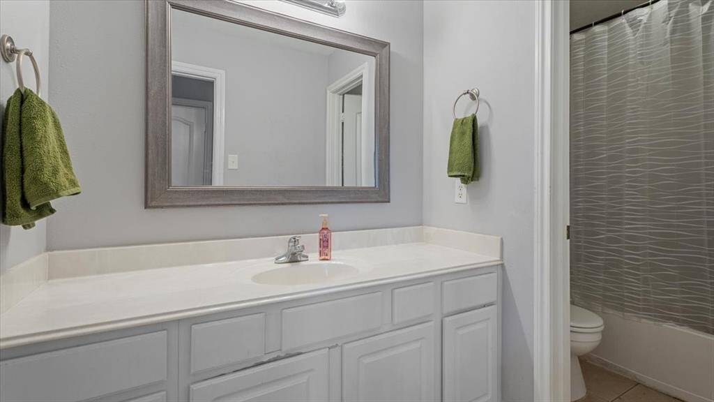 Both upstairs bathrooms offer generously sized vanities with ample counter space—perfect for busy mornings.
