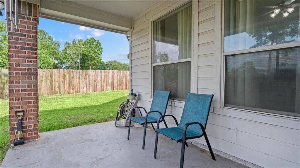 Covered outdoor area ideal for grilling, playtime, or relaxing with pets and family