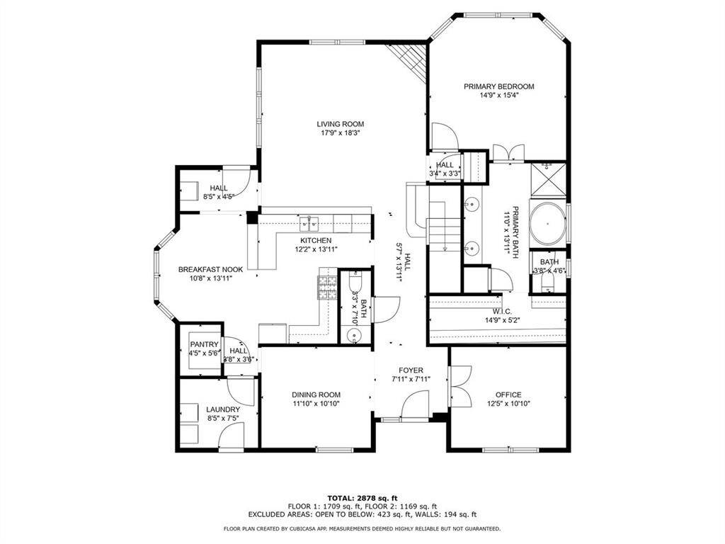 First-floor floor plan offering a clear layout of living spaces, kitchen, and primary suite.