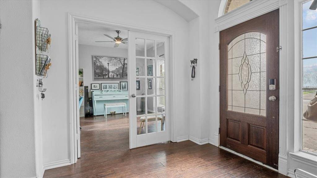 The study features elegant French doors and is flooded with natural light—ideal for working from home.