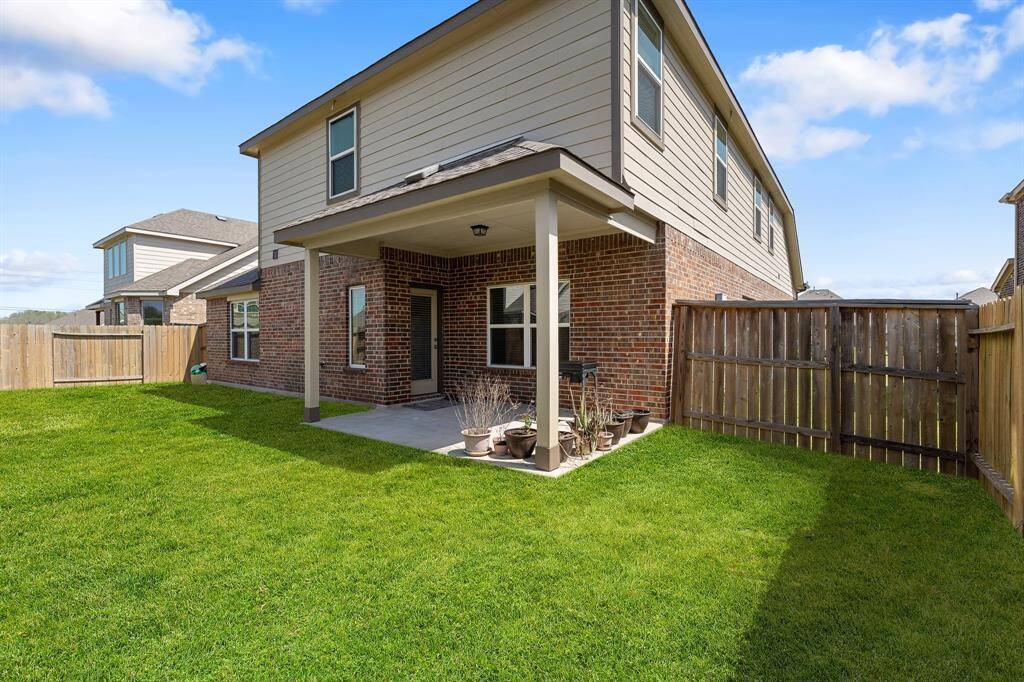 Another view of the beautiful outdoor living area designed for both relaxation and entertainment, featuring a covered patio.