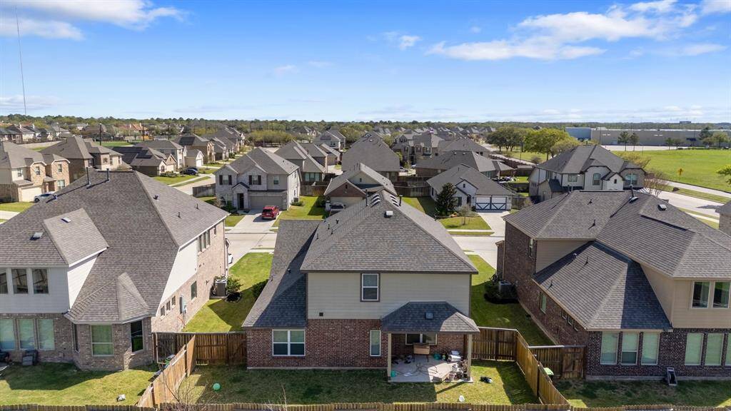 This breathtaking exterior shot captures the beauty of the back of the home, featuring an inviting outdoor living area. The well-designed layout seamlessly blends indoor and outdoor spaces, offering the perfect setting for relaxation and entertainment.
