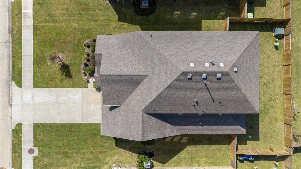 Overhead view showcasing the oversized lot, with a double-wide driveway and welcoming walk way adding grandeur and convenience.