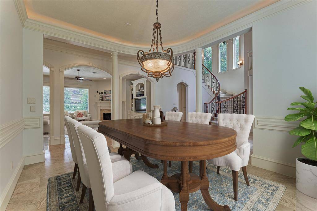 Dining room has superb sightlines through arched openings into the den and the expansive windows to the backyard oasis. *This photo is virtually staged*