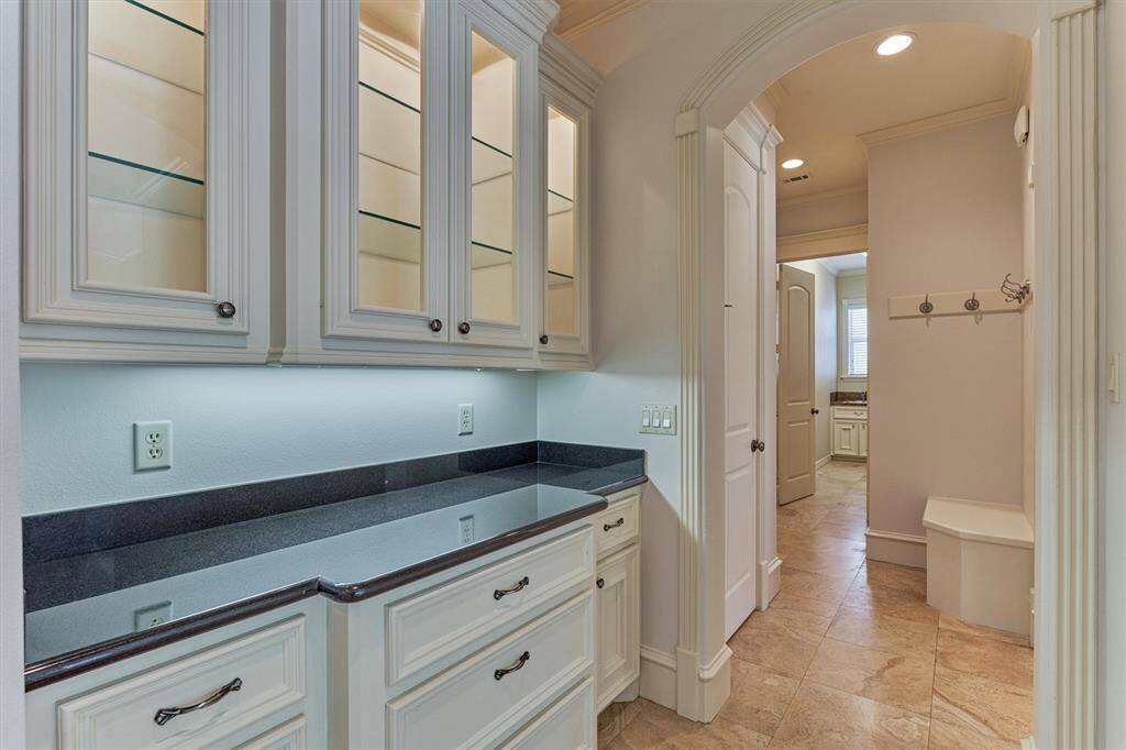 Beautiful glass-paneled butlers pantry with accent lighting - a perfect venue for meal or bar service!