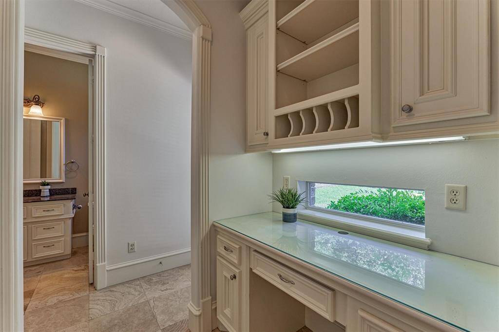 Passthrough from kitchen features a built-in desk and organizer.