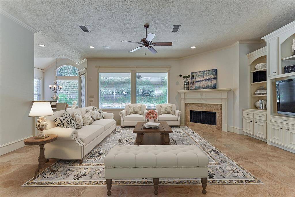 Expansive windows provide panoramic views to the backyard oasis from the den! *This photo is virtually staged*