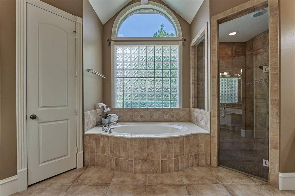Step inside the luxurious owner's retreat bathroom with vaulted ceiling!