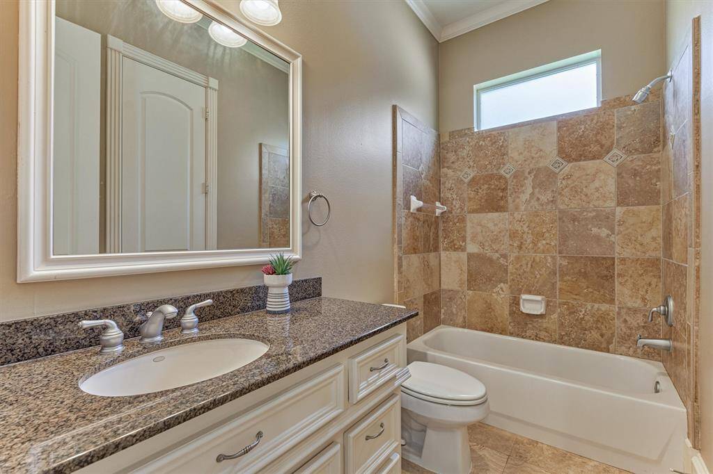 En-suite bath for downstairs secondary bedroom and also near the exterior door to serve dual purpose as a pool bath with separate hallway door - genius in design!