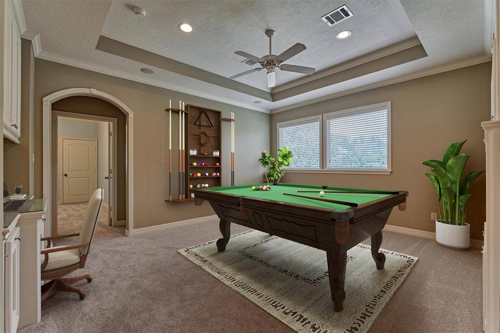 Game room upstairs is spacious and showcases a trayed ceiling and arched doorways. Note: the fresh carpet! *This photo is virtually staged*