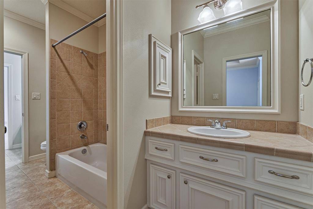 Jack & Jill bathroom for secondary bedrooms #2 and #3 with separate vanities and tub/shower combo.