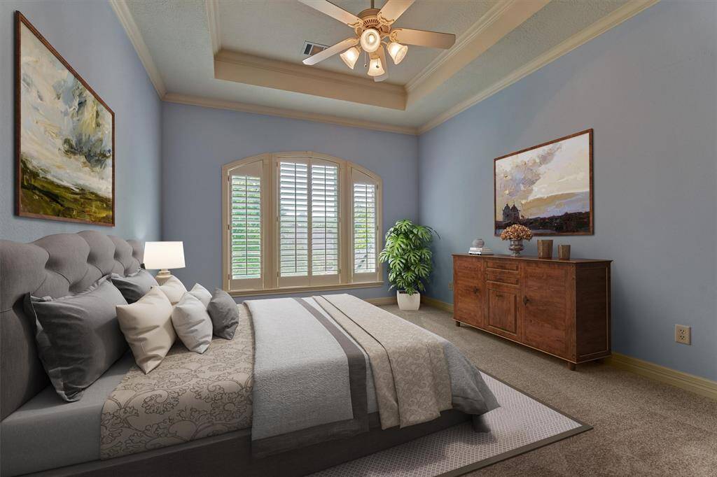 Secondary bedroom #4 is spacious with fresh carpeting, walk-in closet, trayed ceiling, and plantation shutters. *This photo is virtually staged*