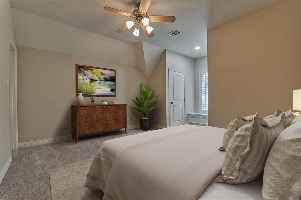 Secondary bedroom #5 is a spacious en suite with fresh carpeting, walk-in closet, built-in window bench, and plantation shutters. *This photo is virtually staged*