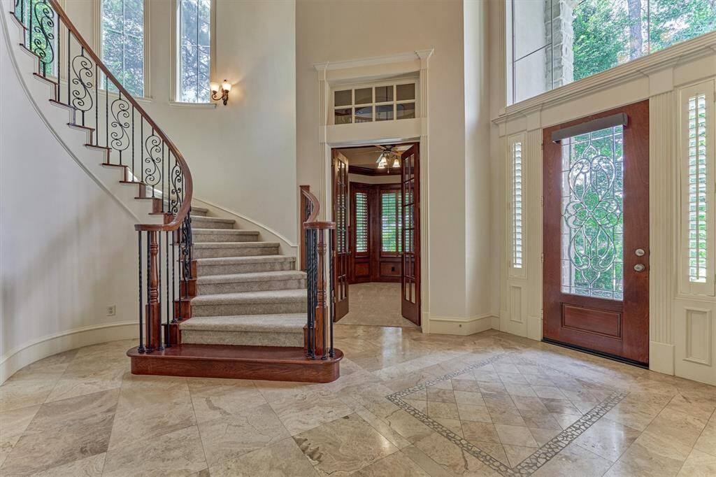 Talk about an entrance! French door entryway leads to paneled study.