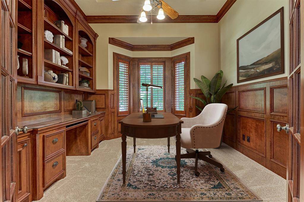 The handsome paneled study is enclosed with French doors boasting built-ins and a bay window. *This photo is virtually staged*
