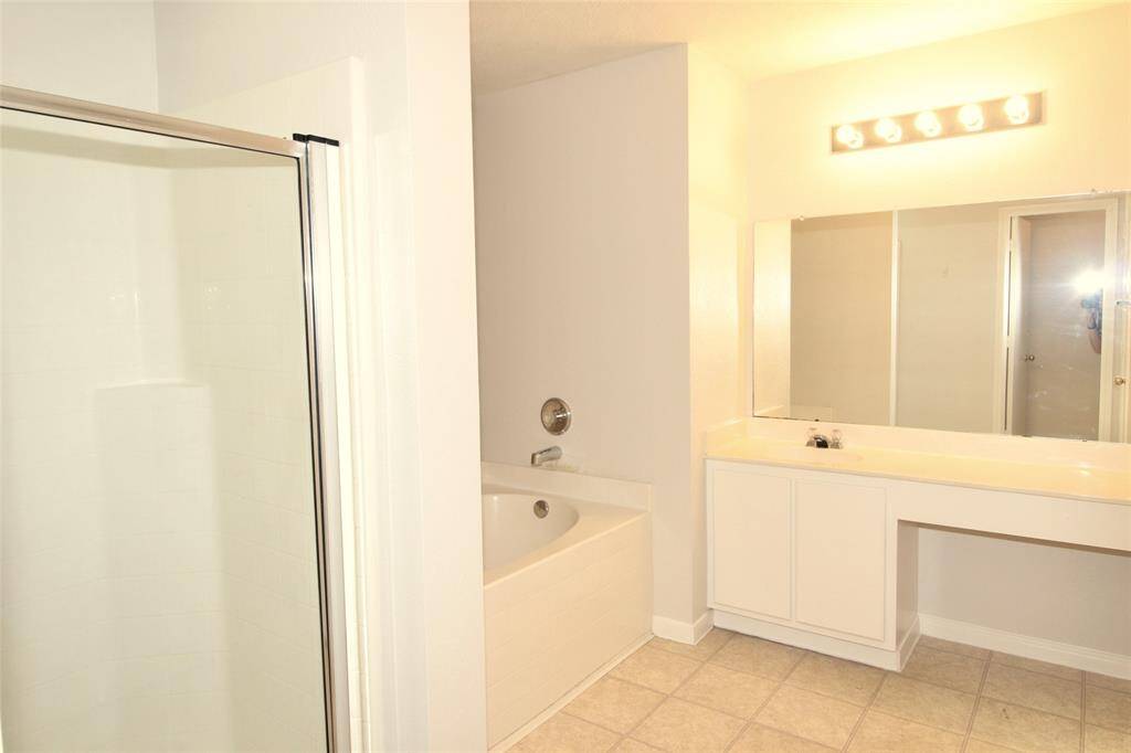 View of the primary bath with a tub plus a separate shower