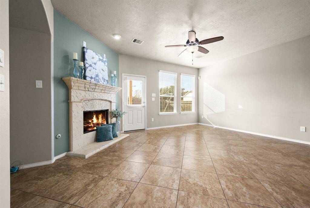 Large family room has the perfect wall space for your sectional sofa. The fireplace will be your favorite seasonal decor focal point.