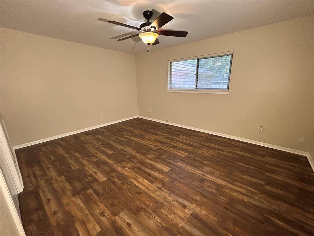 Primary bedroom featuring 2 walk in closets and linen cabinets