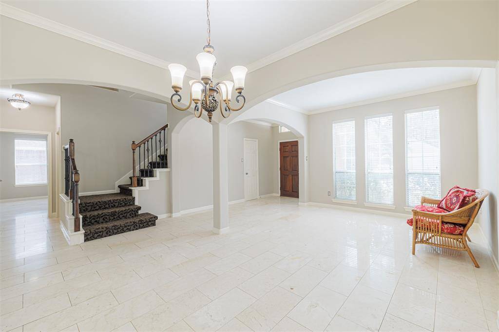 Staircase features wrought iron spindles.