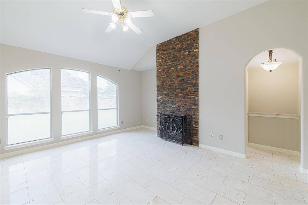 A view of the family room showing the hall way to the right that leads to the primary suite.