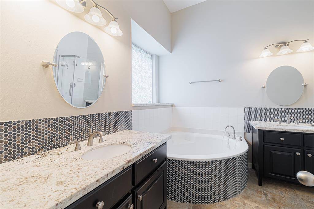 Primary ensuite bath features double vanities and a large walk-in closet.