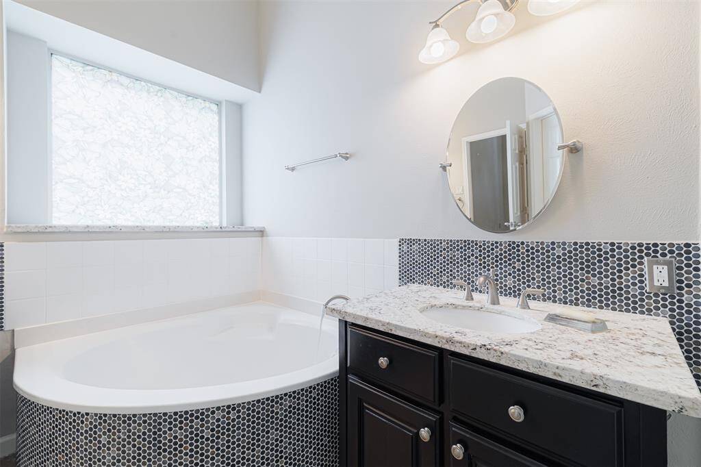 Primary bath also features a corner garden tub.