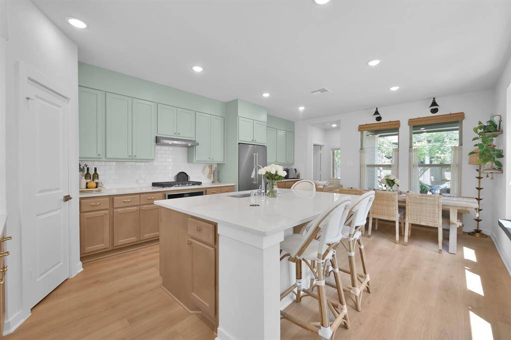 Stunning! Quartz countertops, 5' x 7' island with storage, an abundance of counters and cabinets, gas appliances, walk-in pantry and enough space for an extended dining table.