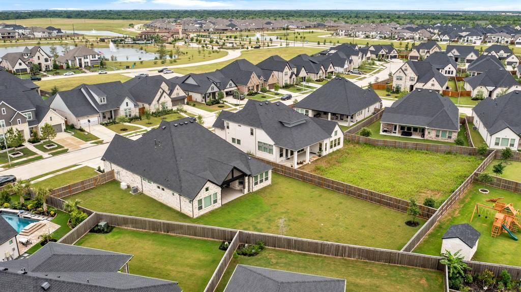 The area is well-maintained, with neatly arranged streets and a nearby water feature, offering a suburban setting ideal for families.
