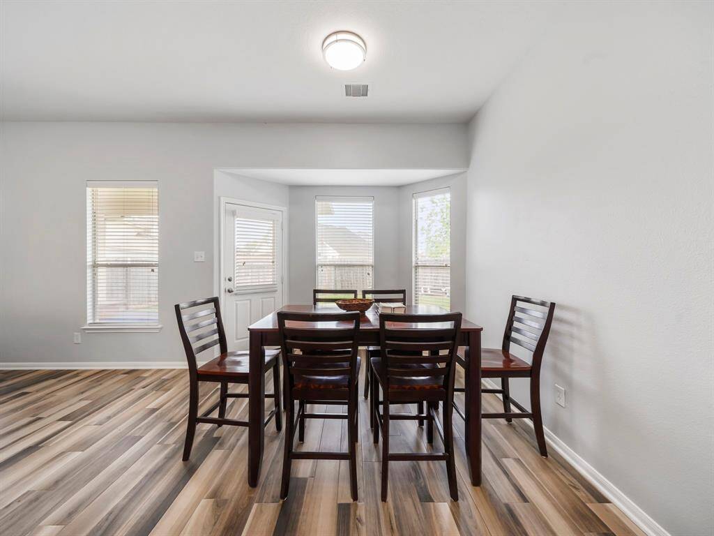 Alternative view of the dining area and location of the back door leading to the large covered patio!