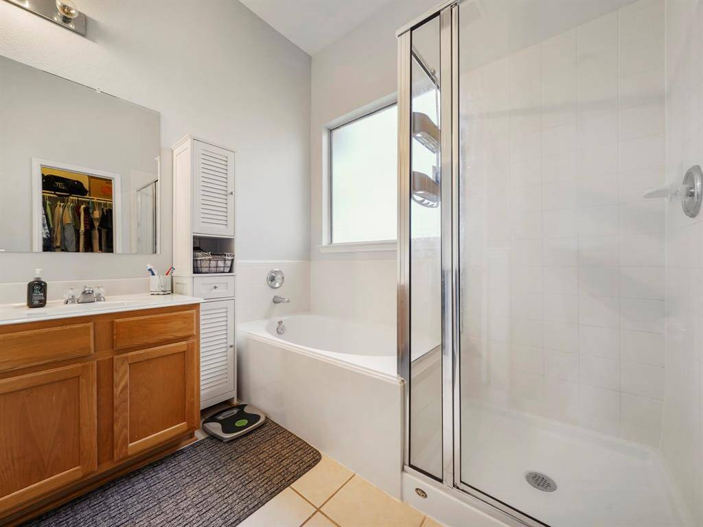 Alternative view of the primary ensuite showcasing the soaking tub and shower.