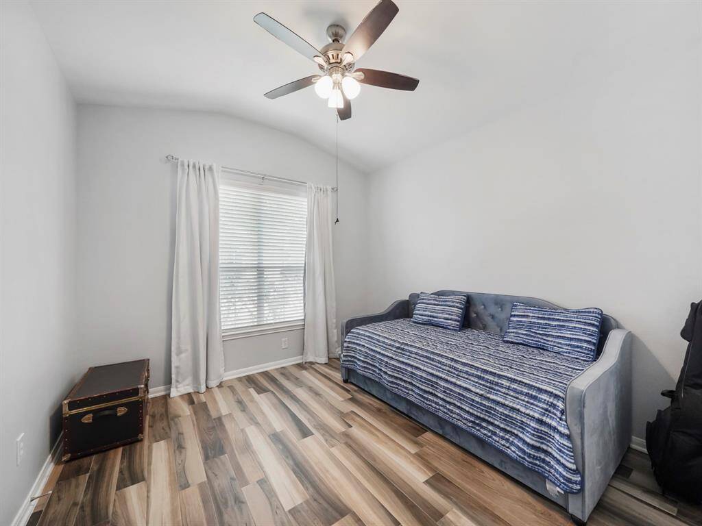 Secondary bedroom #1 in the front of the home features high ceiling with large windows bringing in tons of natural light!