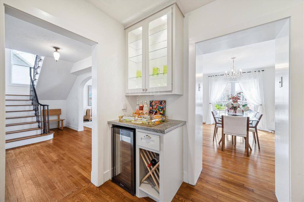 Kitchen's wine and beverage station, view of Formal Dining Room and elegant stairwell- the centerpiece of the home.