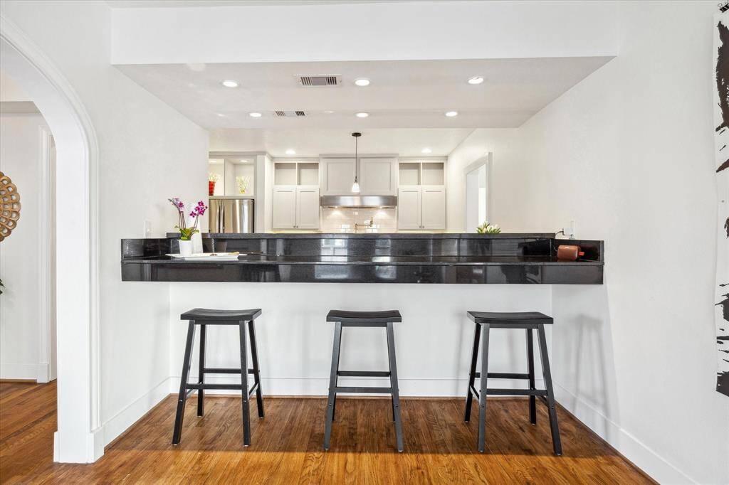 Kitchen serving/bar seating near the center of the home offers multiple possibilities for entertaining.