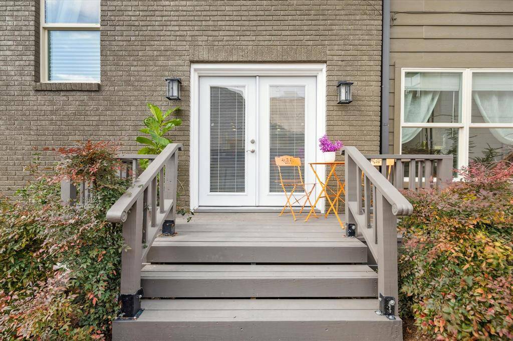 The side porch entry from driveway via French doors into Kitchen serving/bar seating flex room