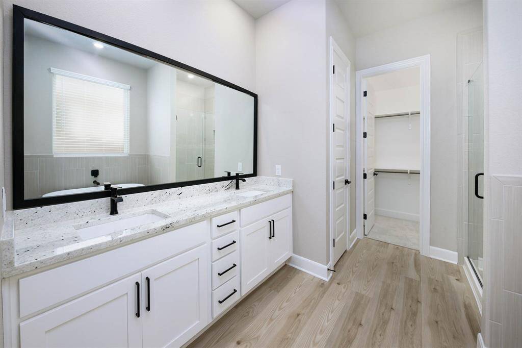 The master bedroom offers an incredible bathroom with a standalone tub, a dual-sink vanity, a sizeable shower and an impressive walk-in closet.