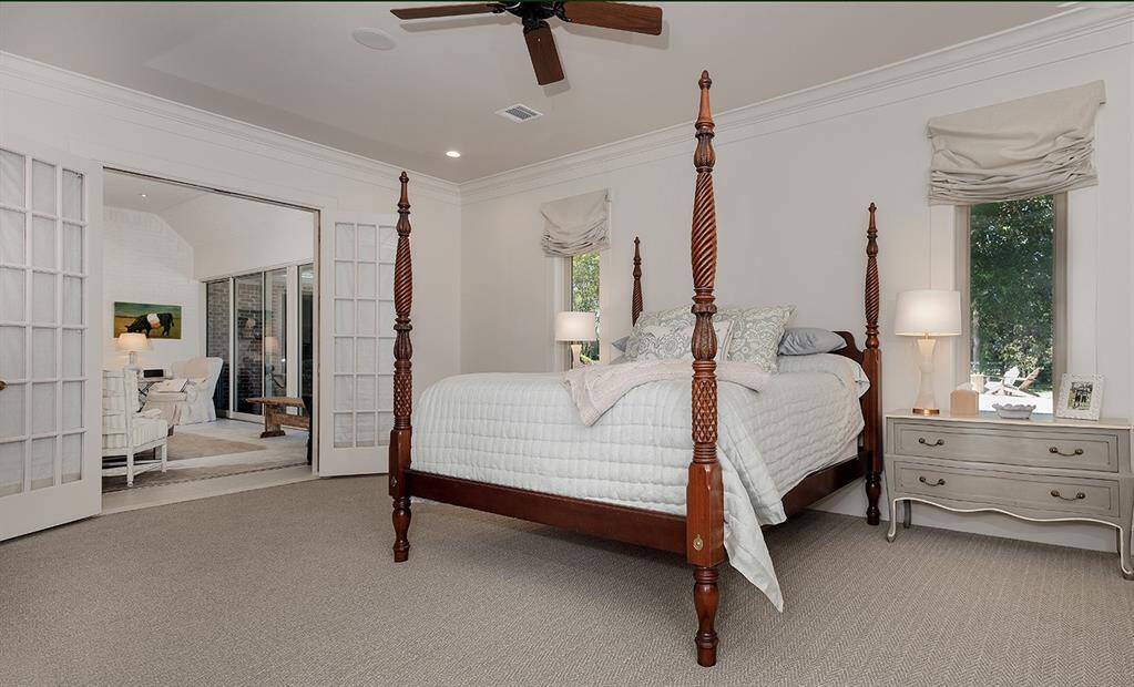 The primary suite with an adjacent sunroom has a newly remodeled bath.