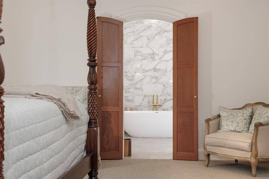 Dual doors lead to the newly remodeled primary bath.