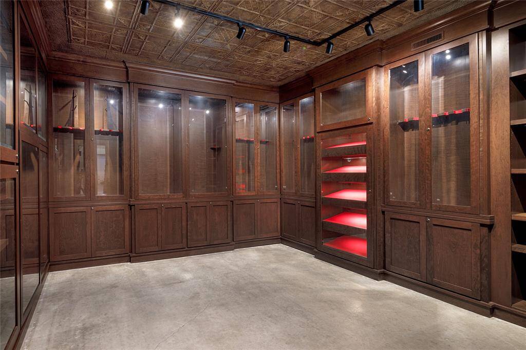 Secure, reinforced room in the barn with keypad entry features light up shelving and cabinetry to house your collection, with a secret room for additional storage.