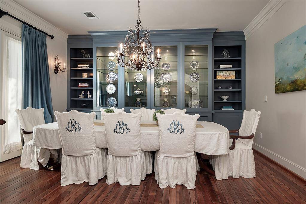 This formal dining room can accommodate many guests and features beautiful crown moulding.