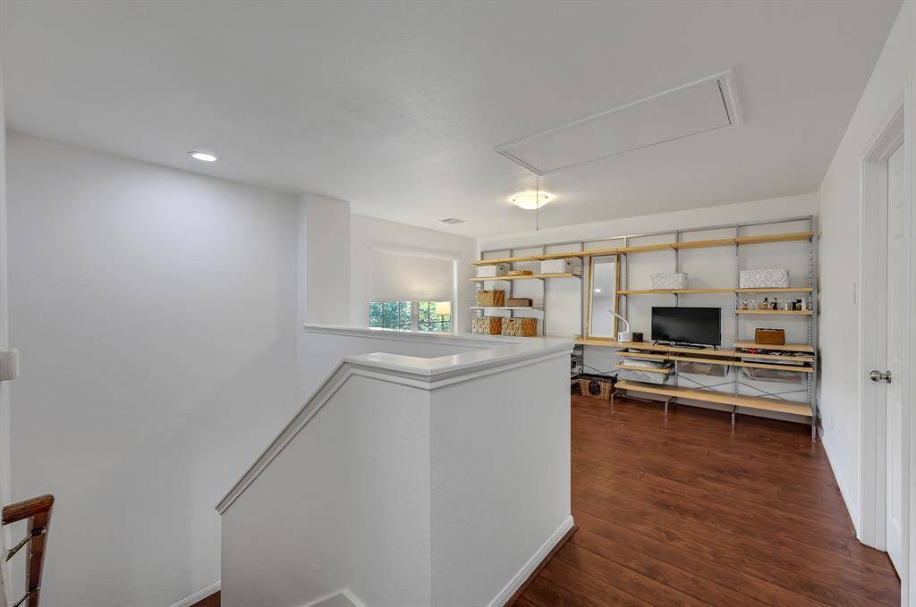 Going upstairs at 21215 Bridge Springs Ln, is a fantastic space that's perfect for so many things. The custom free-standing shelving in the area can be a homework area, gaming area or so many things. The shelves are adjustable, so there are endless possibilities. The upstairs of the home has no carpet, and it features engineered wood floors guaranteeing a cozy feel to the upstairs. The paint is a bright color. The windows have gorgeous corded light filtering roller shades in Serene White in the whole home.