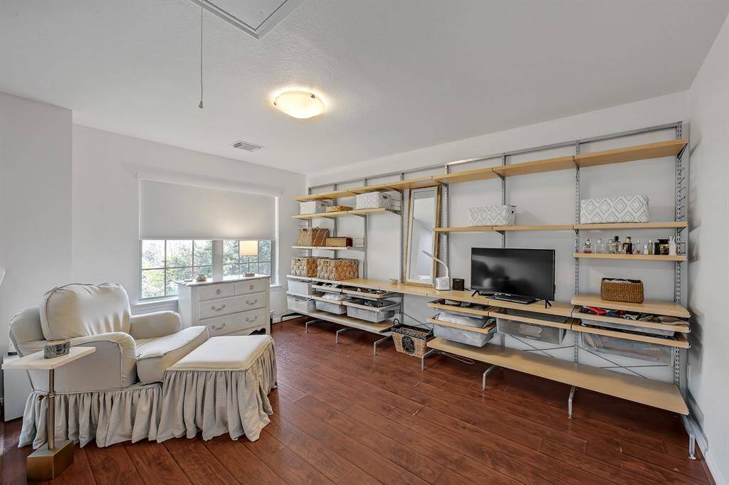 Going upstairs at 21215 Bridge Springs Ln, is a fantastic space that's perfect for so many things. The custom free-standing shelving in the area can be a homework area, gaming area or so many things. The shelves are adjustable, so there are endless possibilities. The upstairs of the home has no carpet, and it features engineered wood floors guaranteeing a cozy feel to the upstairs. The paint is a bright color. The windows have gorgeous corded light filtering roller shades in Serene White in the whole home.
