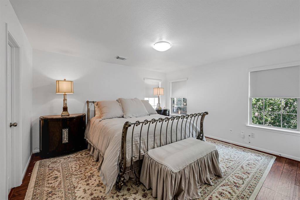 The Primary Bedroom at 21215 Bridge Springs Ln, is a great space that includes an ensuite. The upstairs of the home has no carpet, and it features engineered wood floors guaranteeing a cozy feel to the upstairs. The paint is a bright color. The multiple windows have gorgeous light filtering roller shades in Serene White in the whole home.