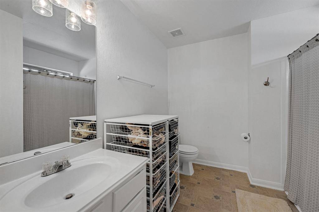 The Primary Bathroom at 21215 Bridge Springs Ln, is a great space. The upstairs of the home has no carpet, and it features neutral tile which adds to the cozy feel to the upstairs. The paint in the Primary Bathroom is a bright color. The light fixtures were also recently updated.