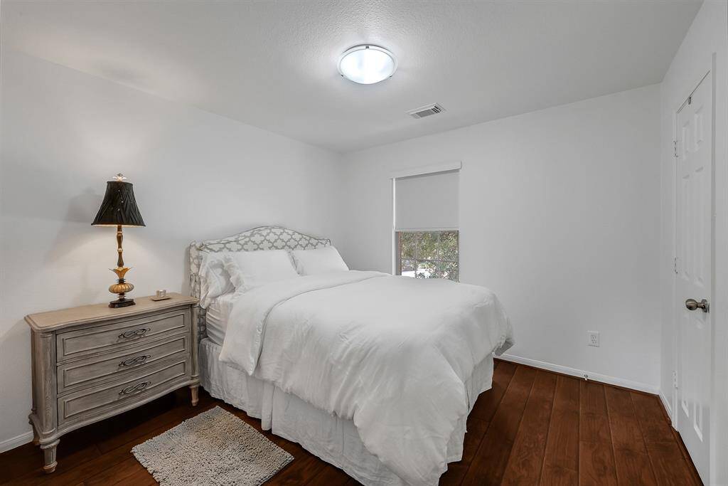 The Secondary Bedroom at 21215 Bridge Springs Ln, is a great space. The upstairs of the home has no carpet, and it features engineered wood floors guaranteeing a cozy feel to the upstairs. The paint is a bright color. The window has a gorgeous light filtering roller shades in Serene White in the whole home.