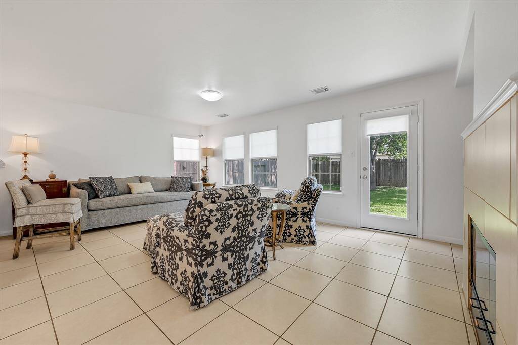 The family room at 21215 Bridge Springs Ln is past the first living area and is also perfect for entertaining guests. It overlooks the kitchen and has access to the backyard. This room enjoys the home's fireplace and it was recently inspected to ensure it's working perfectly. The downstairs of the home has no carpet, and it features large neutral tile with complementary grout. The paint is a bright color. The windows have gorgeous cordless light filtering roller shades in Serene White in the whole home.