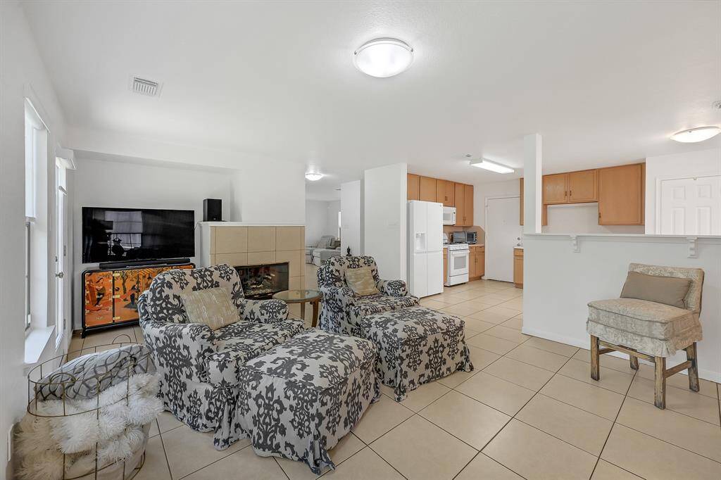The family room at 21215 Bridge Springs Ln is past the first living area and is also perfect for entertaining guests. It overlooks the kitchen and has access to the backyard. This room enjoys the home's fireplace and it was recently inspected to ensure it's working perfectly. The downstairs of the home has no carpet, and it features large neutral tile with complementary grout. The paint is a bright color. The windows have gorgeous cordless light filtering roller shades in Serene White in the whole home.