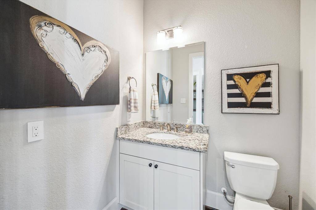 Powder bath is located off entry hallway opposite the wine bar.