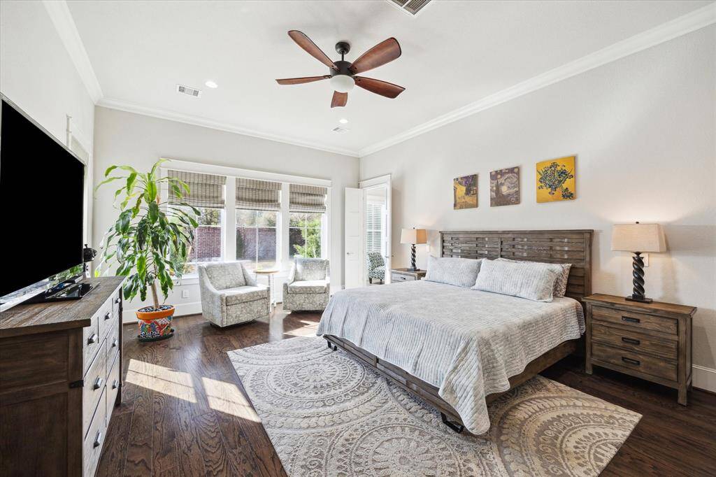 Primary suite overlooks the beautiful backyard.