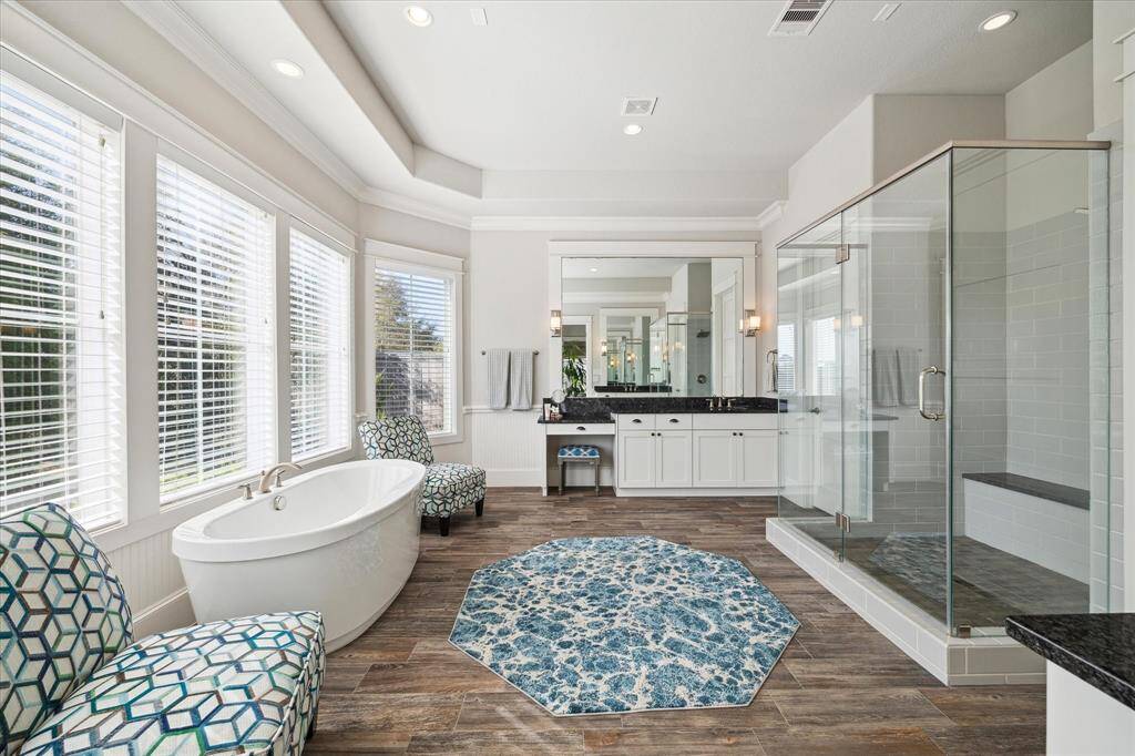 Primary bath features a soaking tub, separate shower, dual sinks and  vanity station.