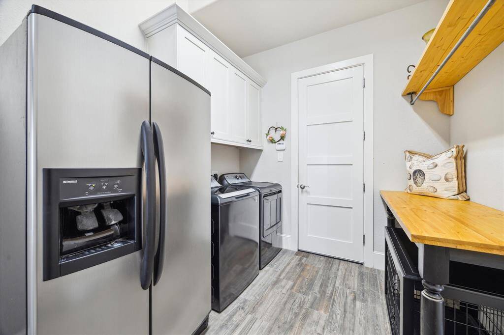 Laundry is located just off the kitchen. It can also be accessed via primary closet.
